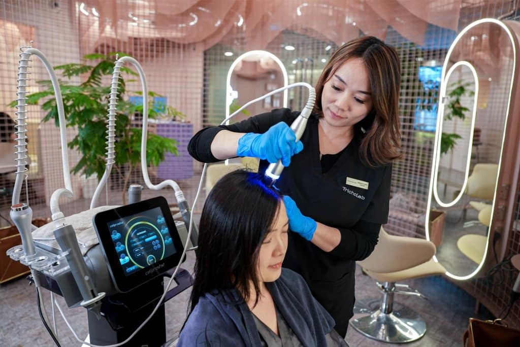TrichoLab professional performing a scalp treatment