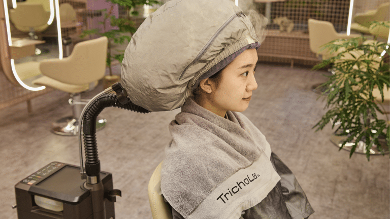 Client receiving a hair-loss prevention scalp treatment